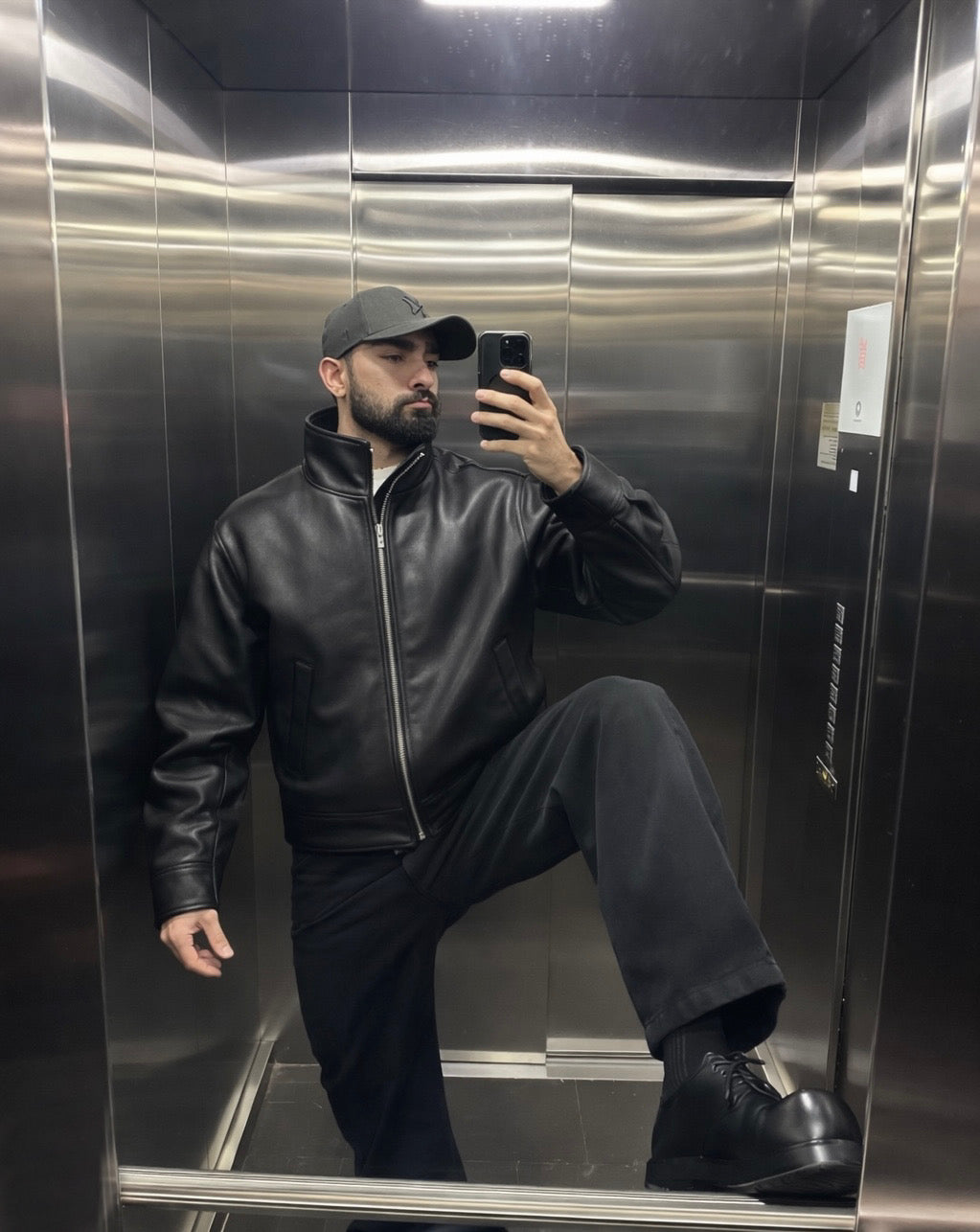 Black leather jacket, styled with black trousers